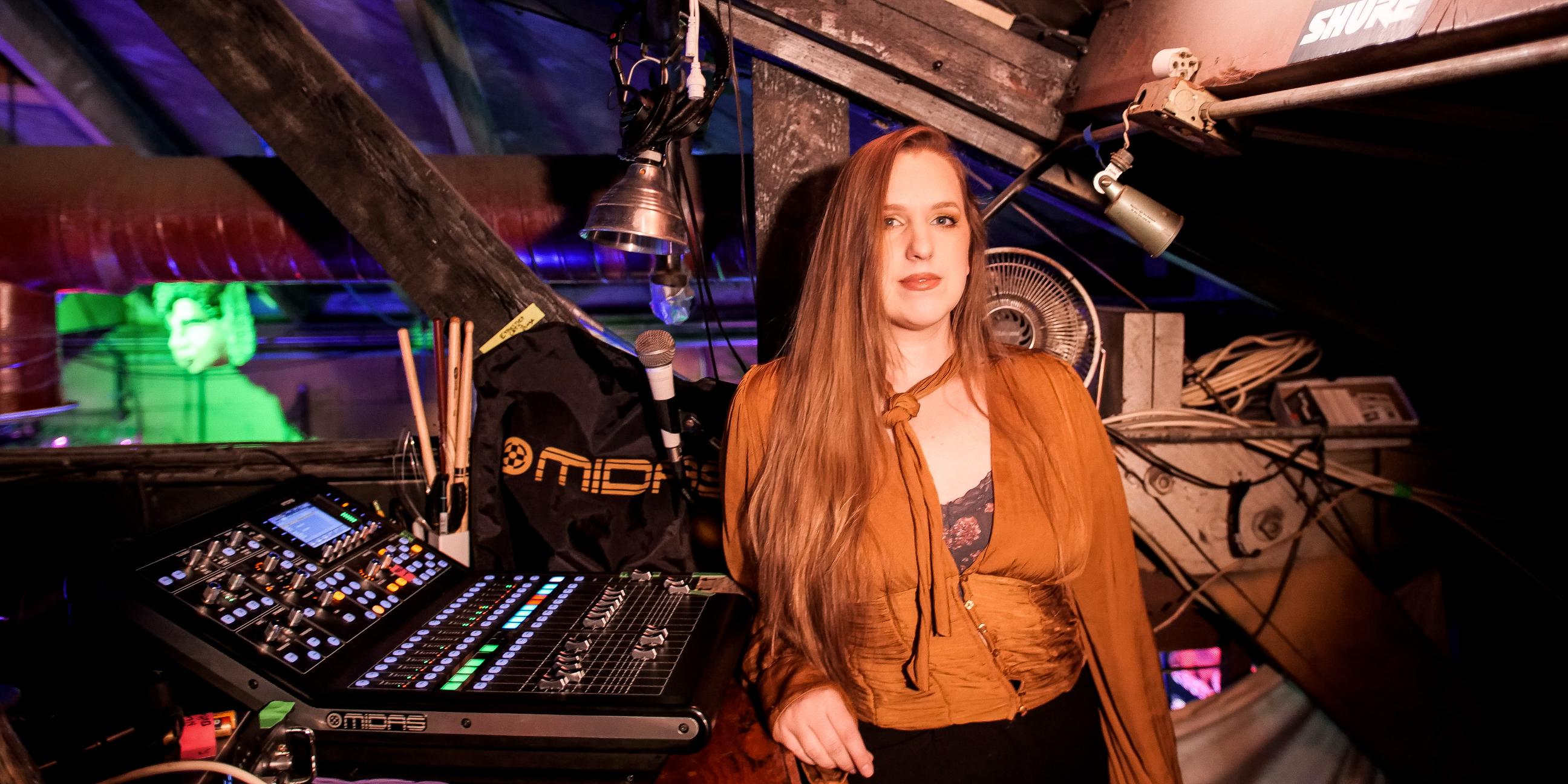 Rebecca Sleeth beside the sound mixing console at Powerhouse Pub in Folsom.